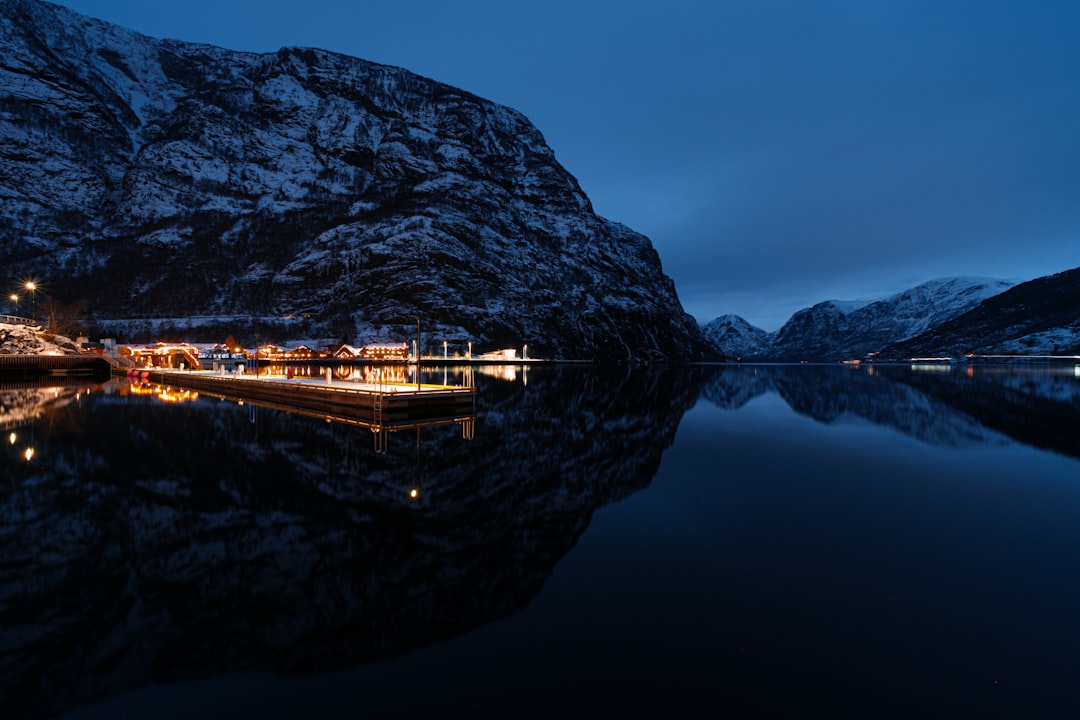 a boat in a body of water with mountains in the background,