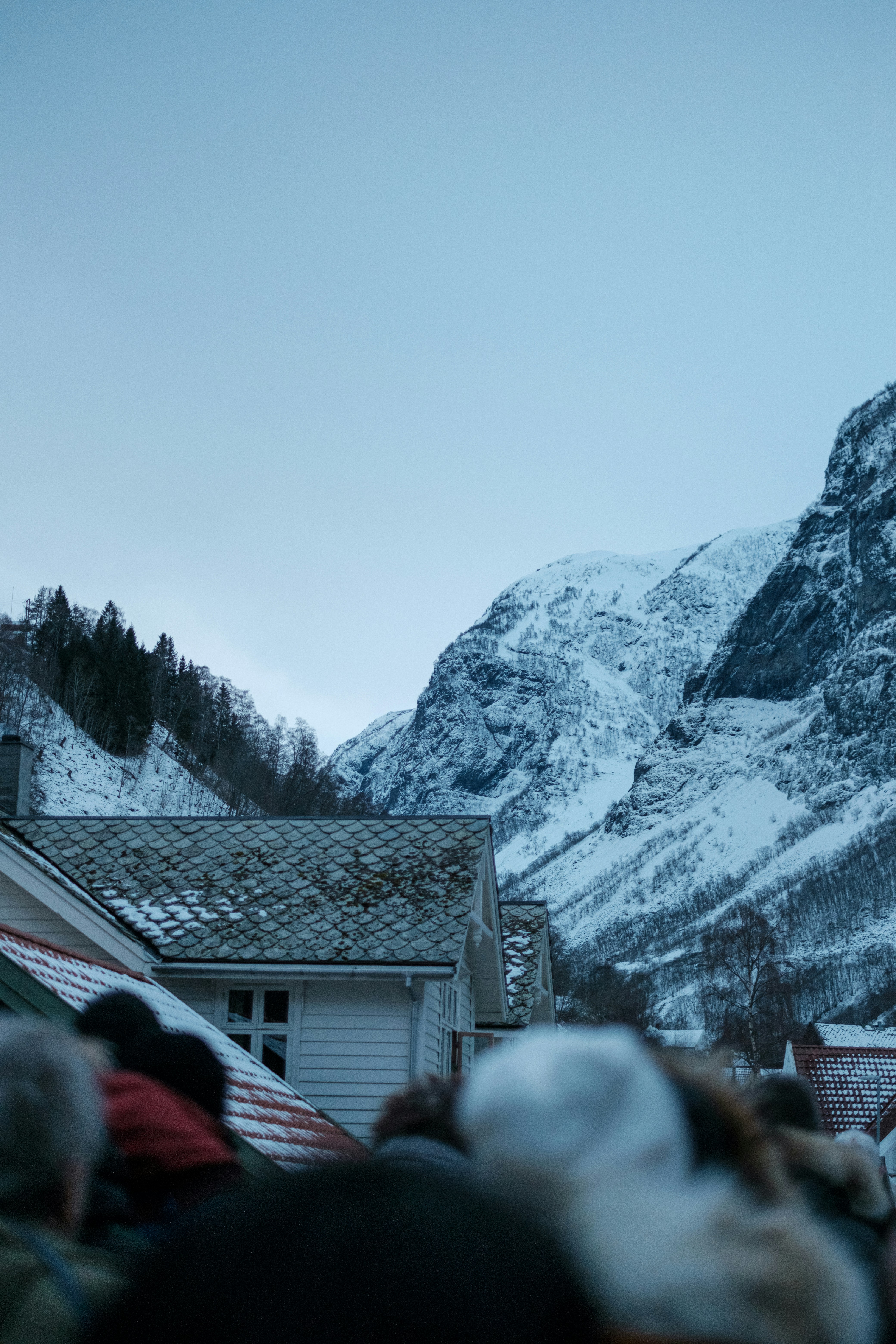 a group of people standing in front of a snow covered mountain