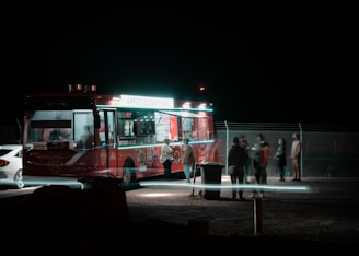 a group of people standing around a food truck