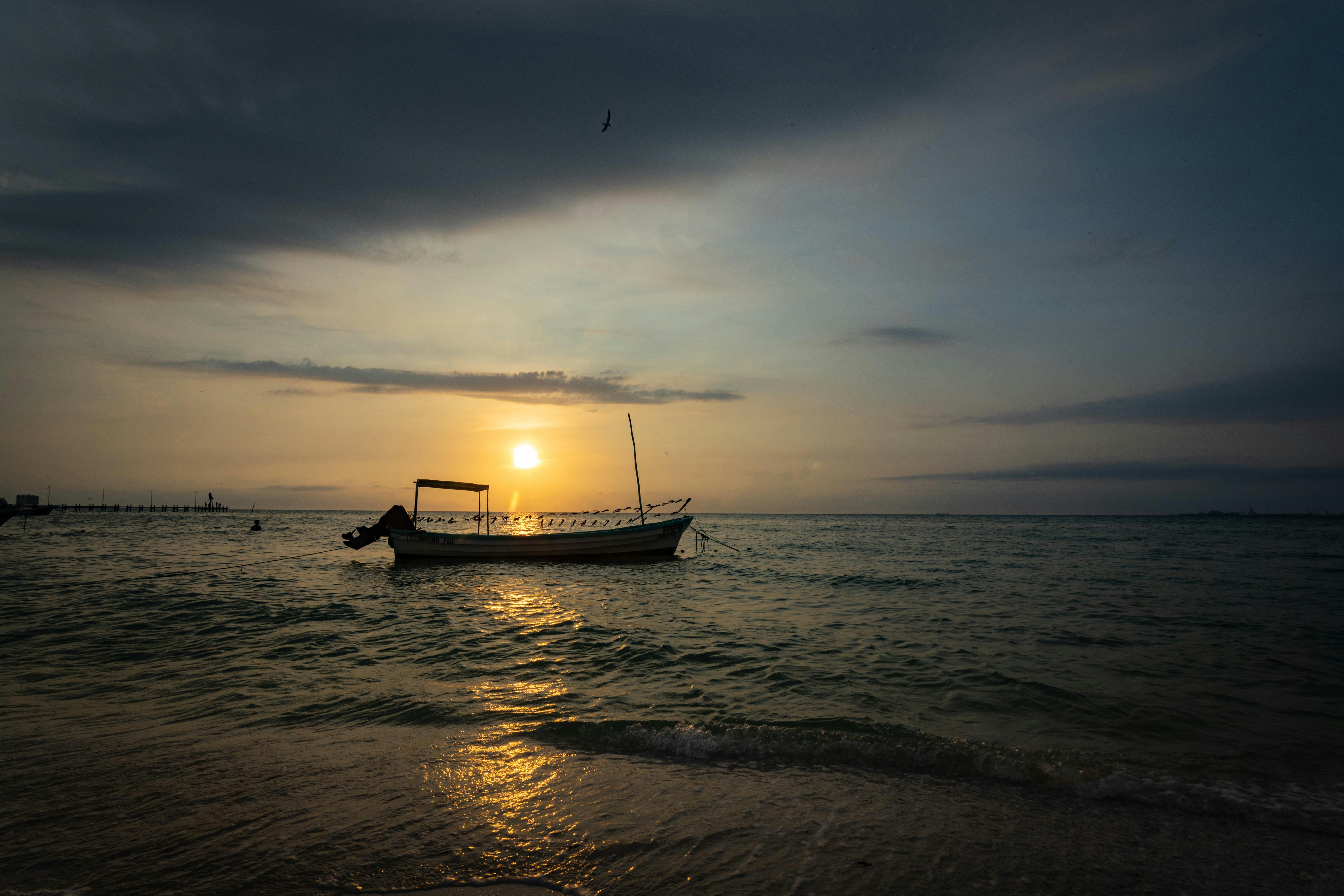 Boat on beach at sunset
