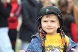 a young boy wearing a jacket and a hat