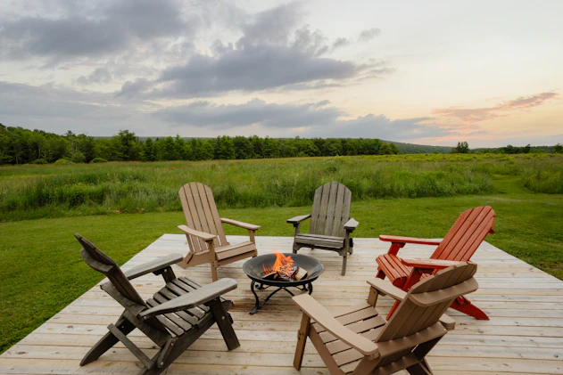 a group of chairs sitting on top of a wooden deck