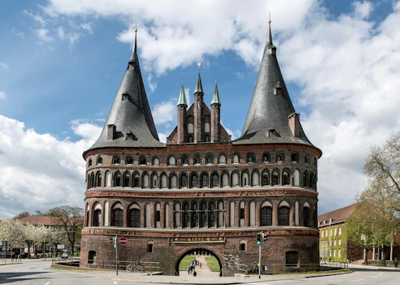 A large brick building with two towers on top of it — Lübeck, Germany