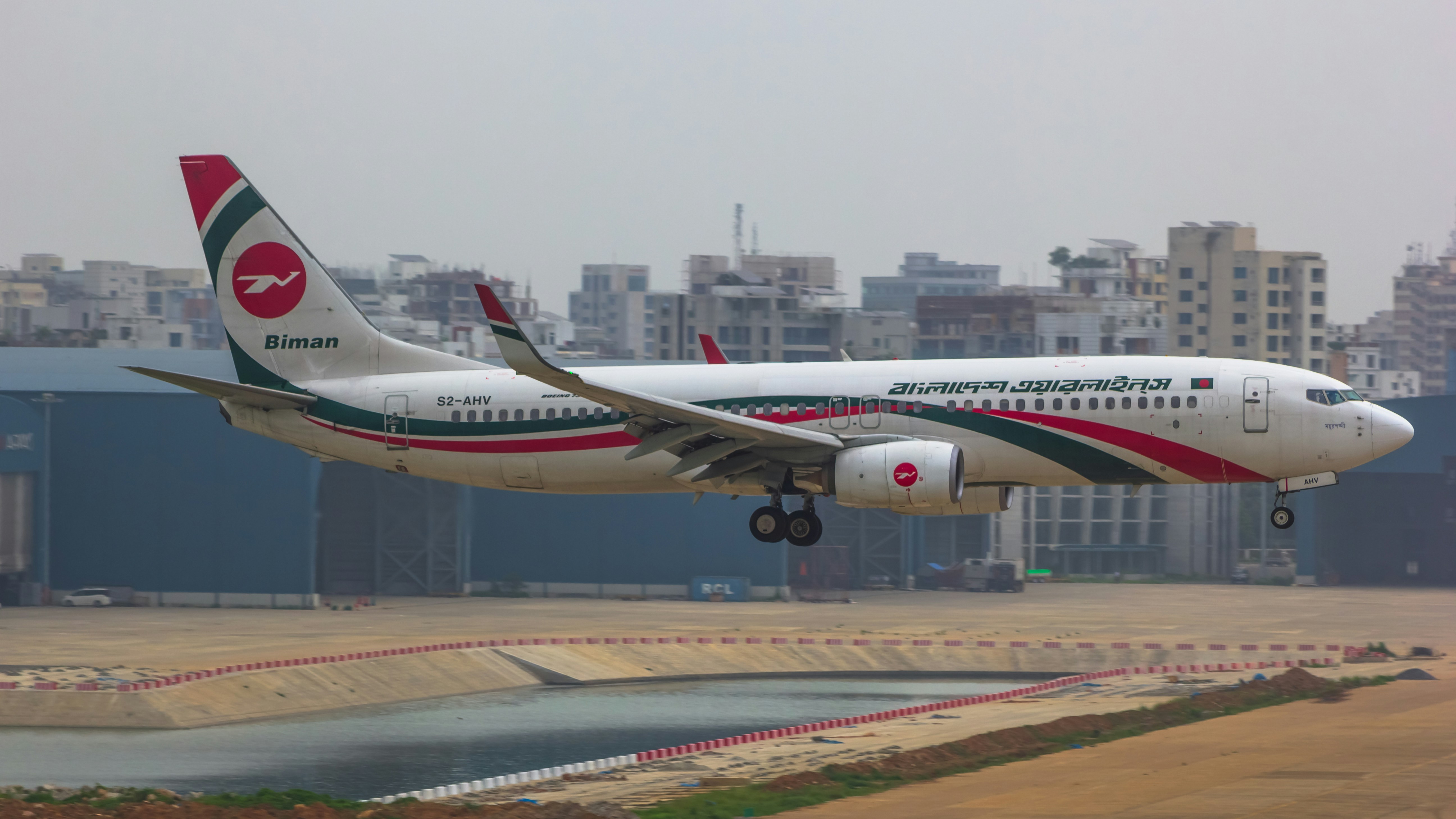 a large passenger jet taking off from an airport runway, 