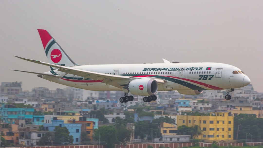 a large jetliner flying through a cloudy sky,