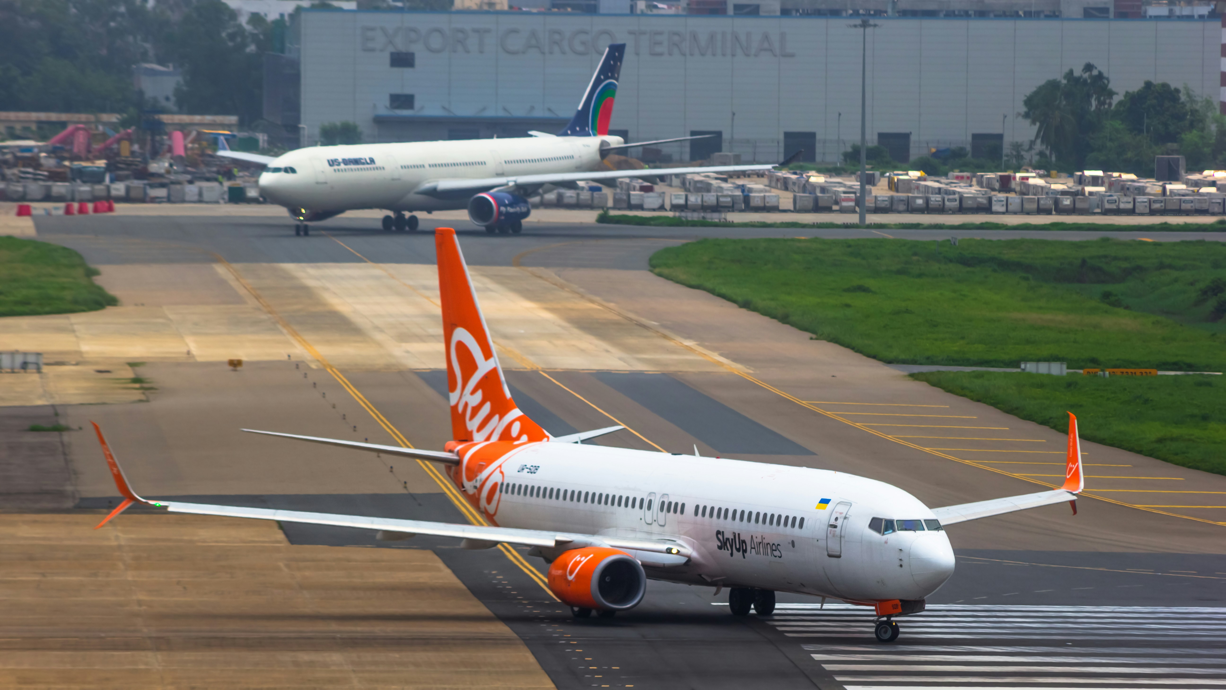 an orange and white plane is on the runway, 