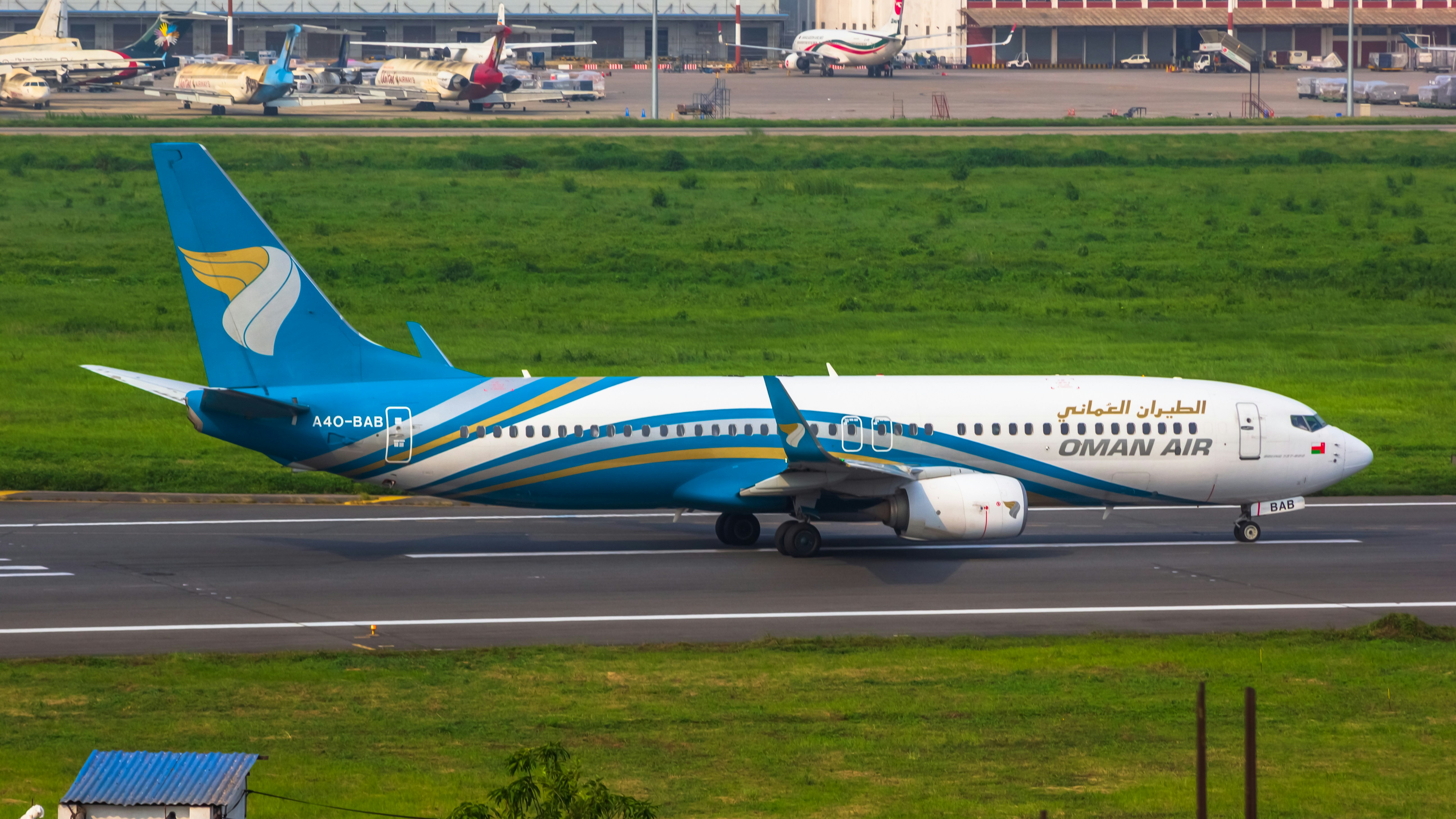 a blue and white airplane is on the runway, 