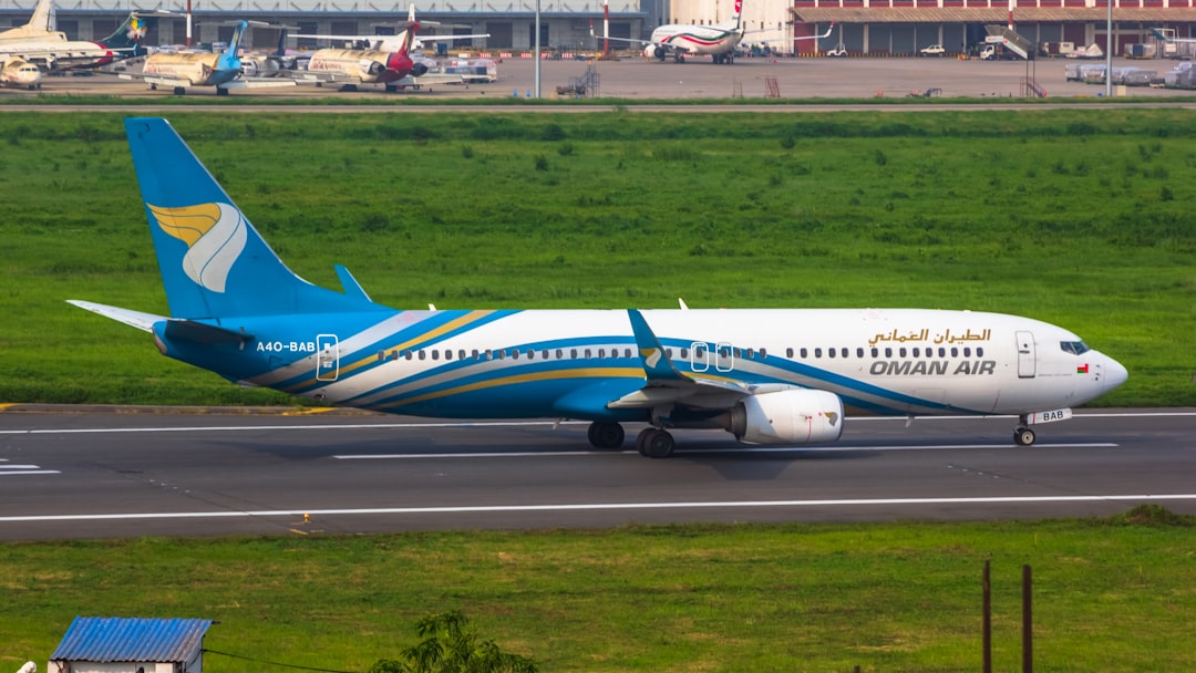a blue and white airplane is on the runway,