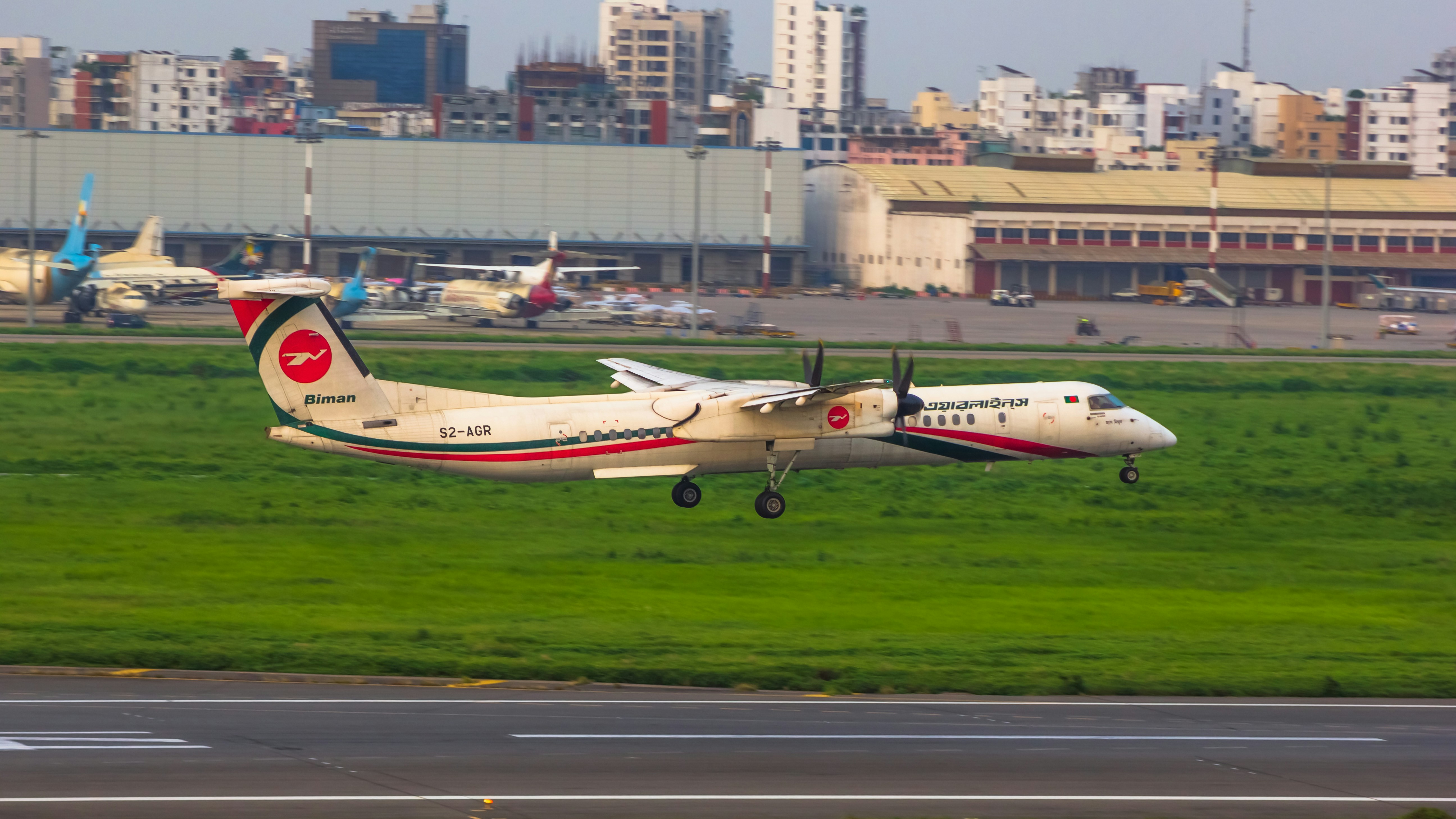 a small plane taking off from an airport runway, 