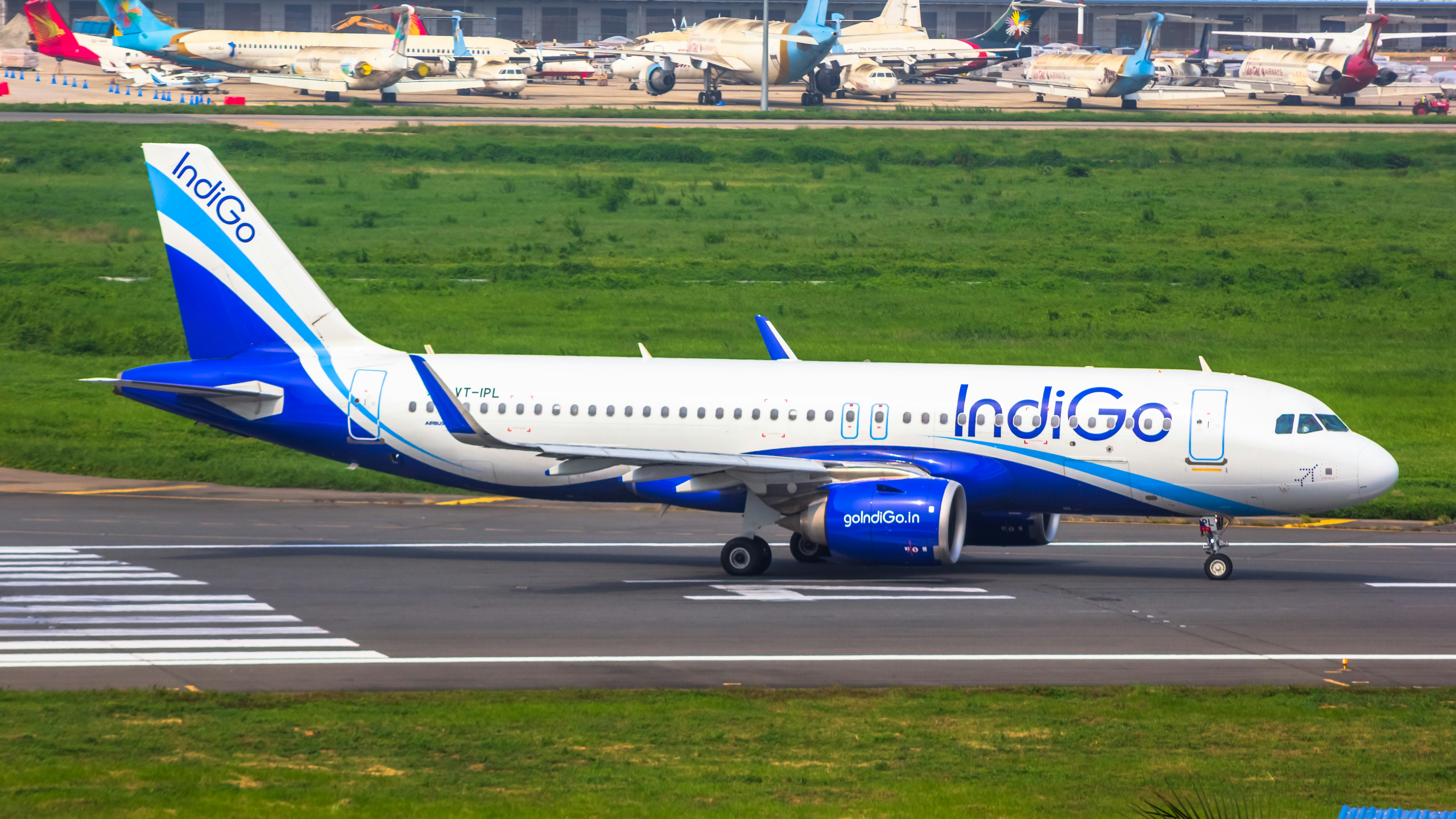 A blue and white airplane is on the runway photo – Free Aircraft Image ...