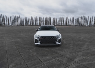 a white car parked in a parking lot