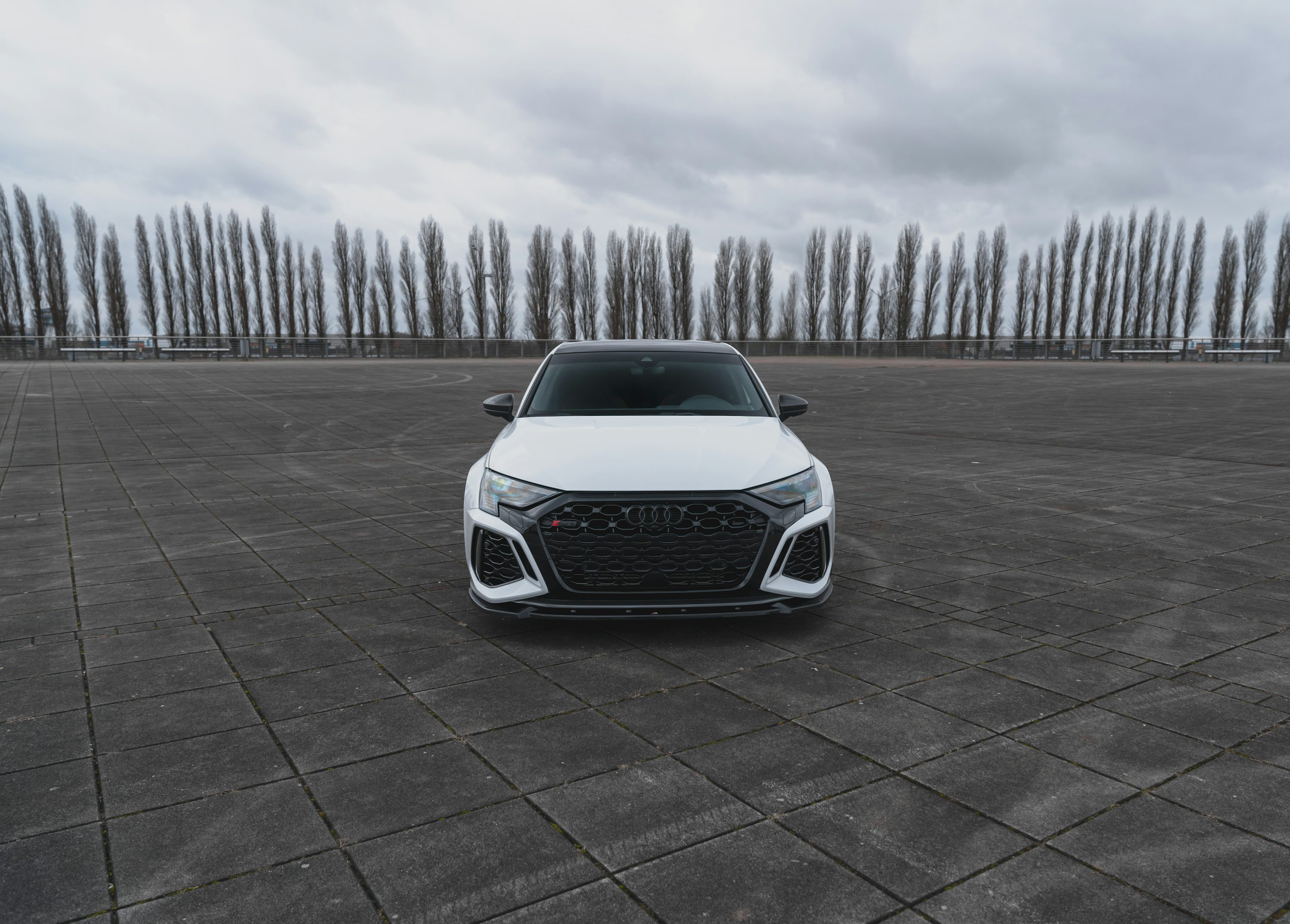 a white car parked in a parking lot