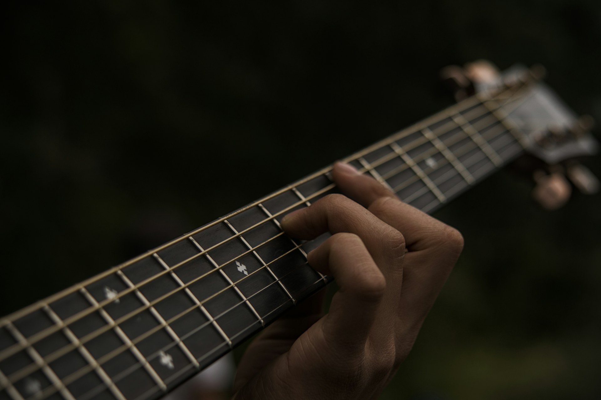 a person playing a guitar with their fingers