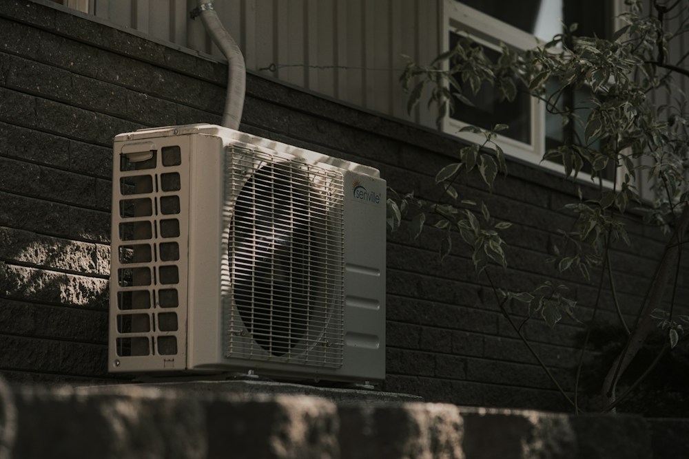 Outdoor heat pump unit beside a house