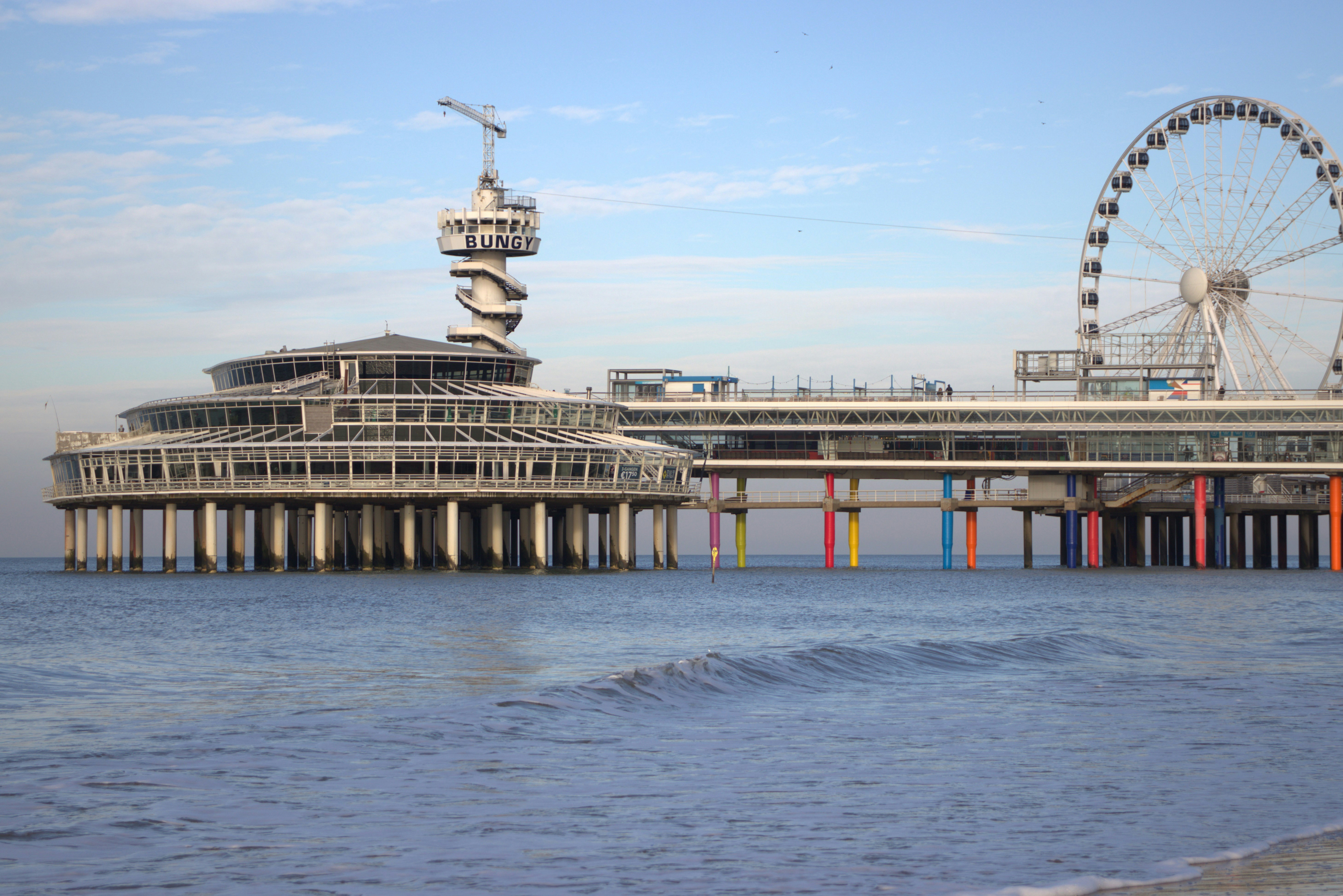 a pier with a ferris wheel in the background