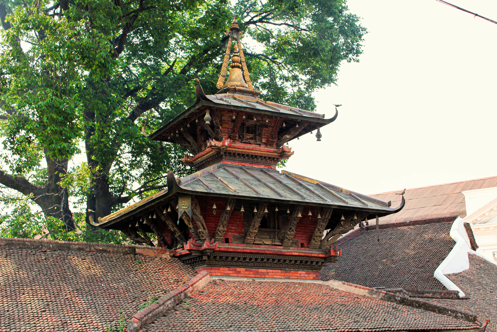 Carved wooden struts and stacked roofs of a Newar pagoda temple in Kathmandu's old city