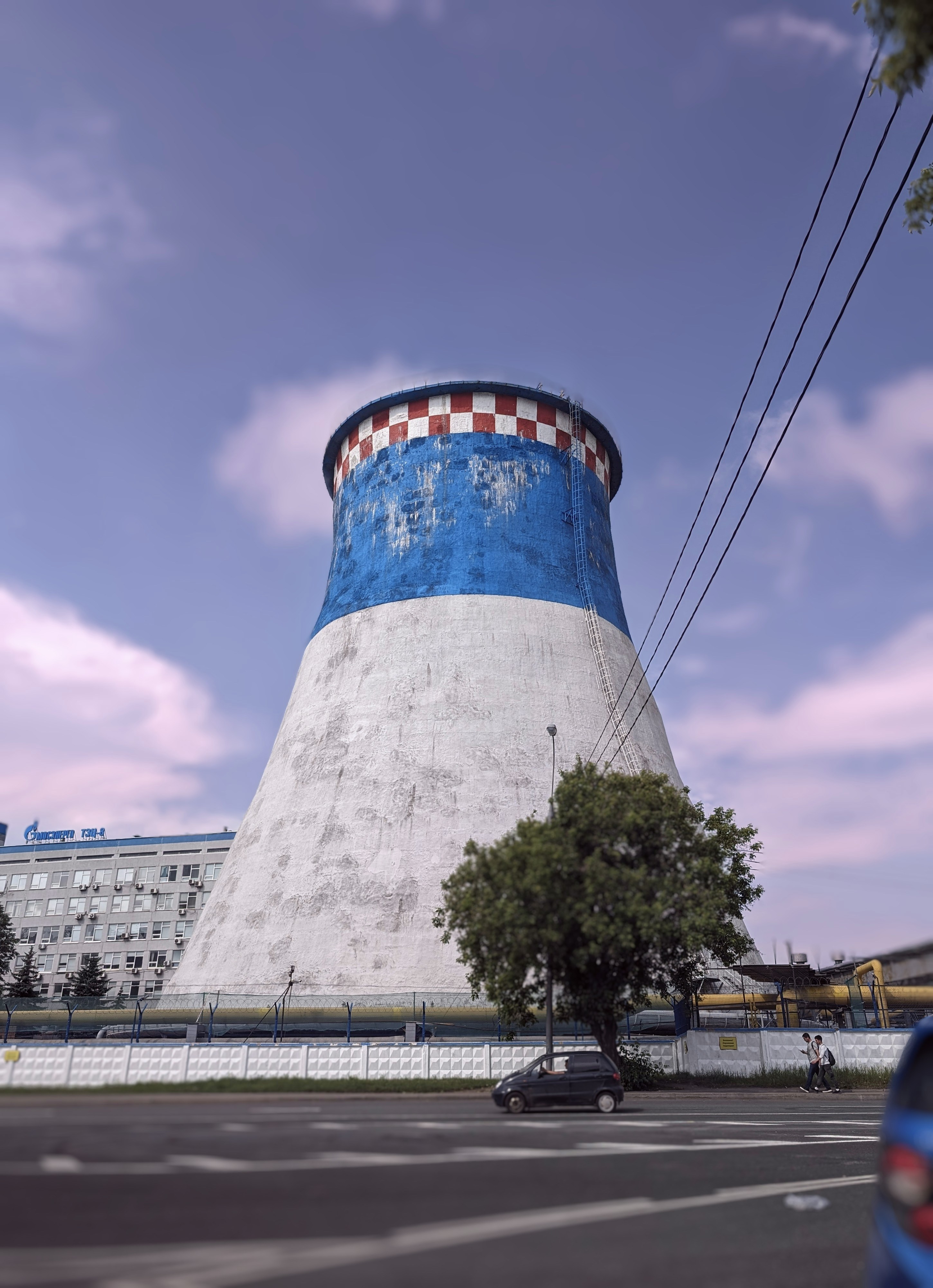 a large blue and white tower sitting on the side of a road