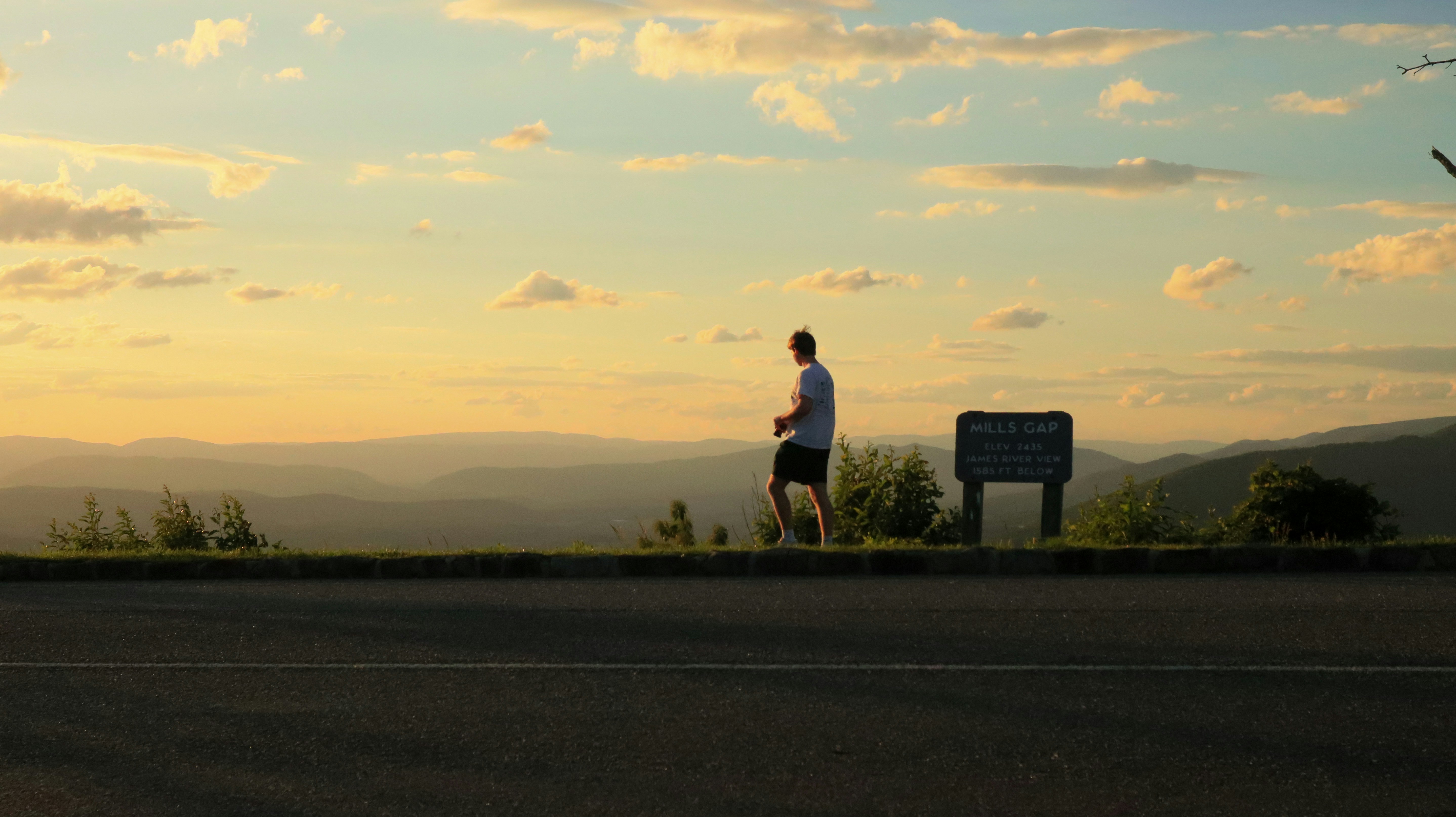 A lone figure walking a mountain ridge at sunrise, embodying the solitude of true leadership