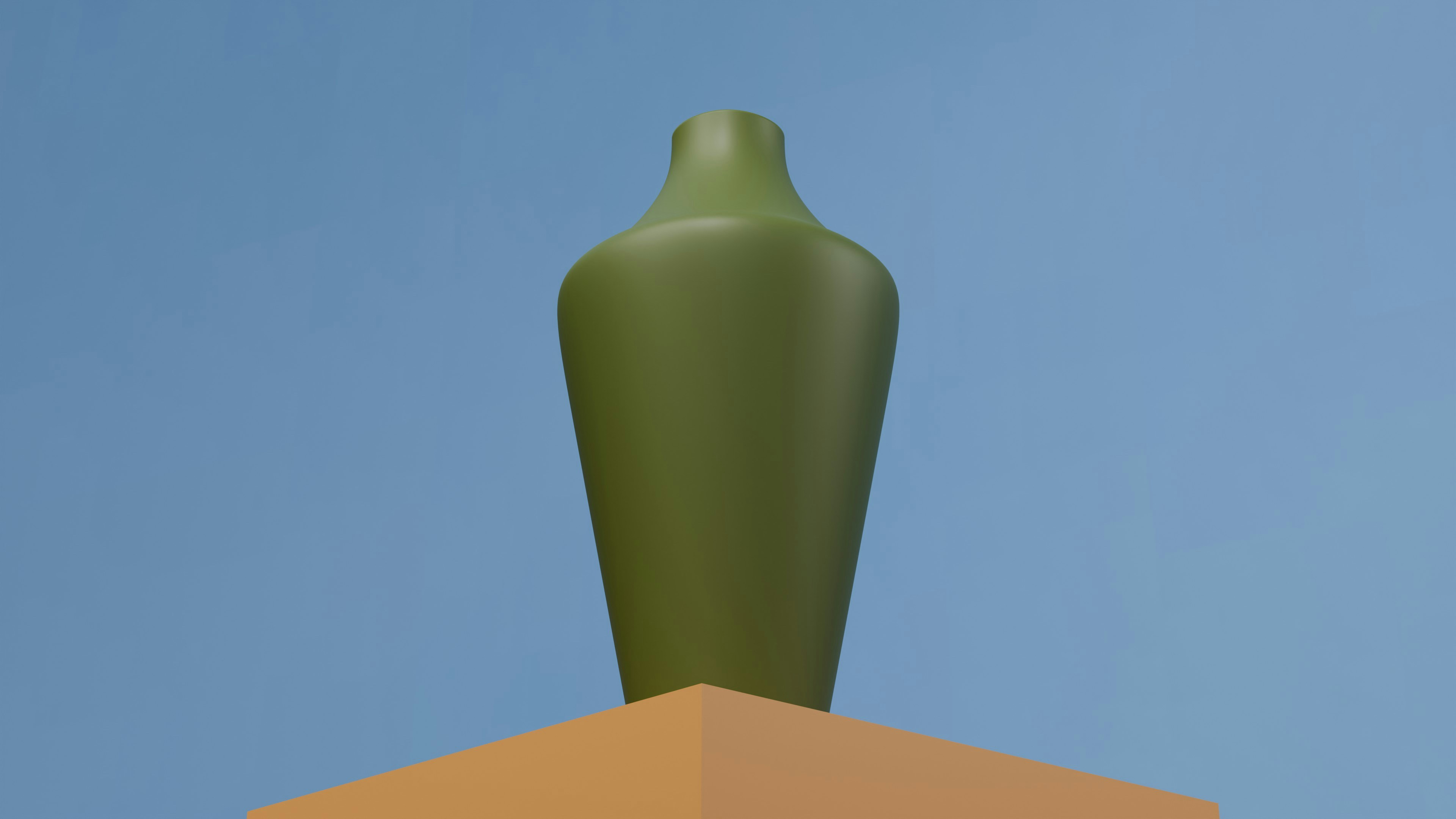 a green vase sitting on top of a box