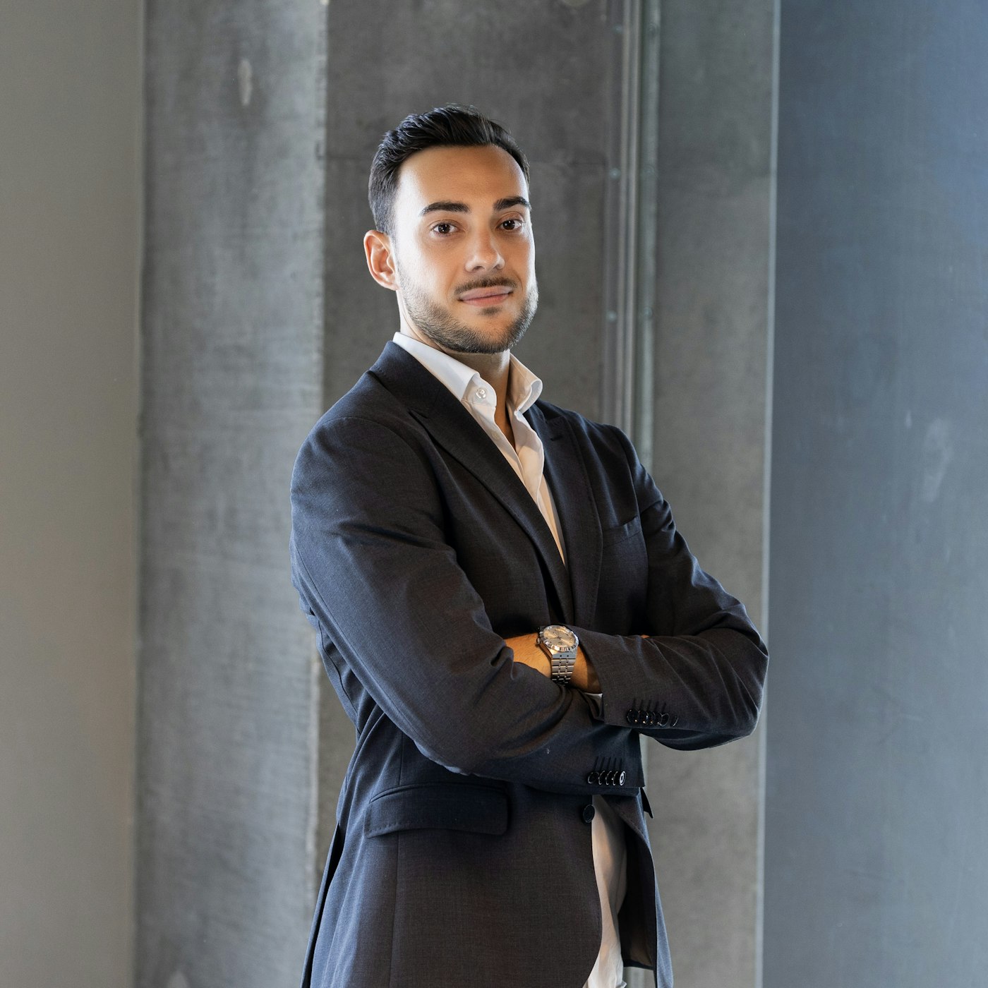 Confident professional in a suit standing in front of a building