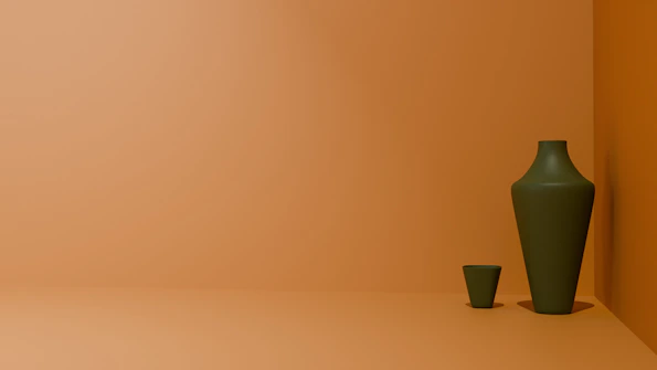 a green vase sitting next to a green cup
