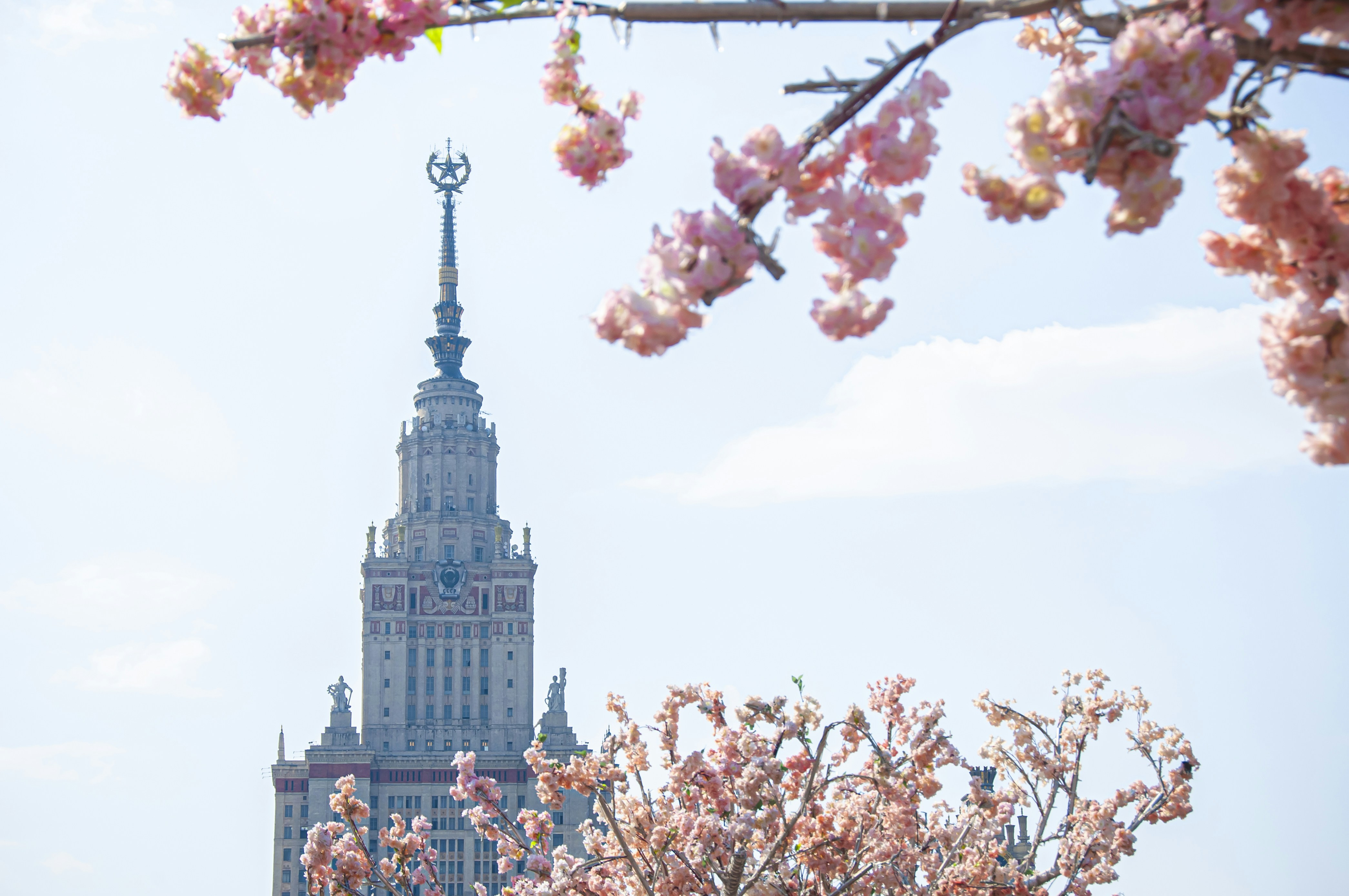a tall building with a clock tower in the background