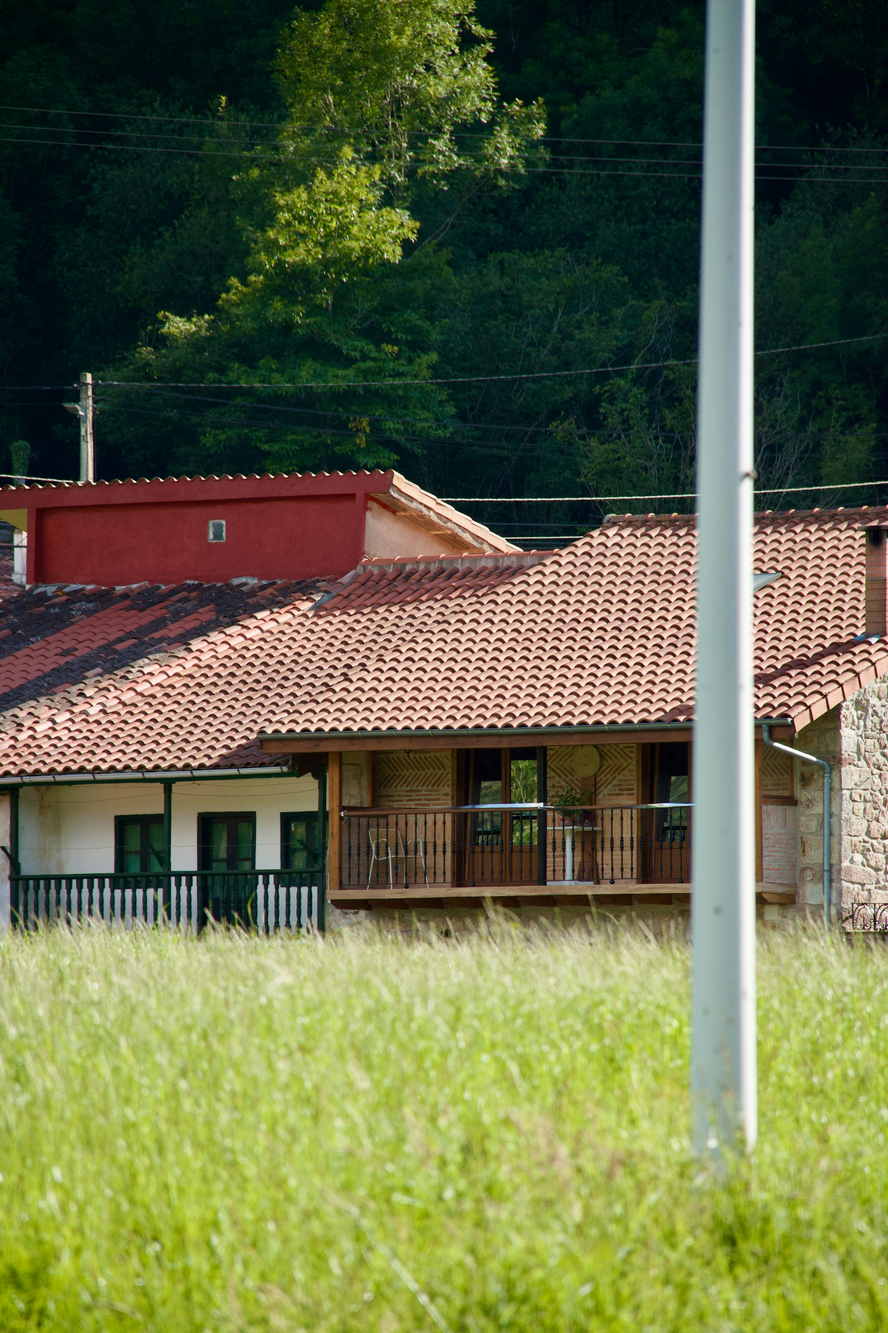 a house in a field with a red roof