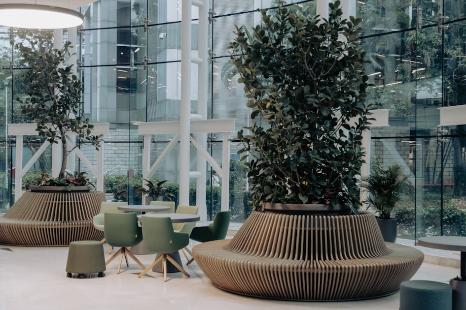 A calm, naturally lit office room with a table, chairs, and potted plants, representing a low-stress workplace.
