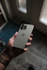 a person holding an iphone in their hand
