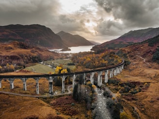 a train traveling over a bridge over a river