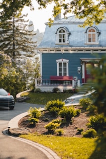 a blue house with a red bench in front of it