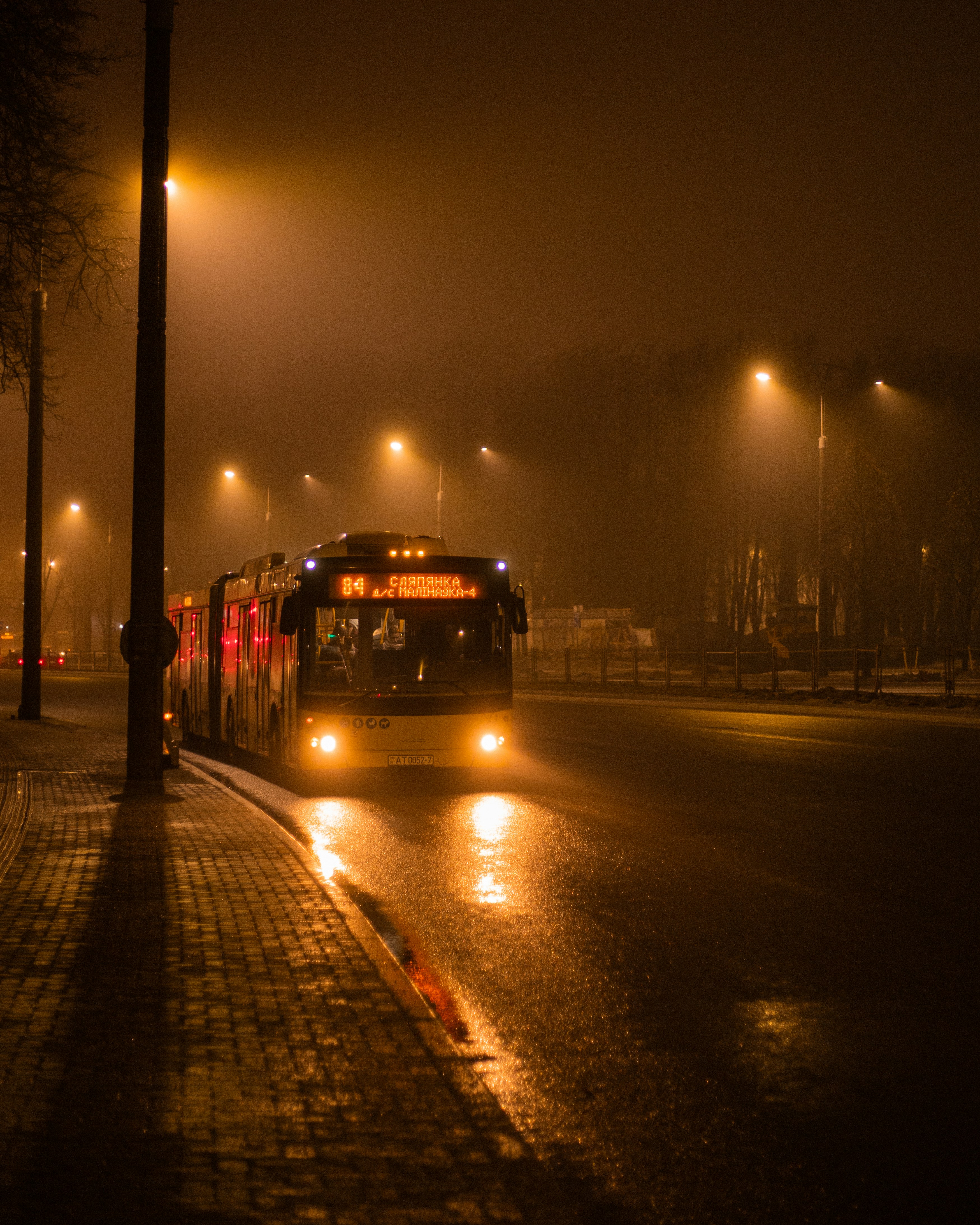 a bus driving down a street at night