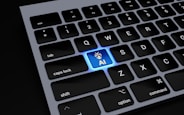 a close up of a keyboard with a blue light on it