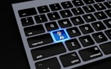 a close up of a keyboard with a blue light on it