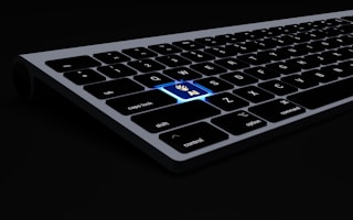 a close up of a keyboard on a black surface