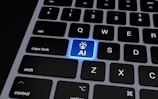 a computer keyboard with a blue light on it