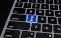 a computer keyboard with a blue light on it