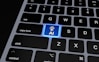 a computer keyboard with a blue light on it