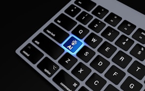 a close up of a keyboard with a blue key