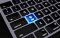 a computer keyboard with a blue light on it