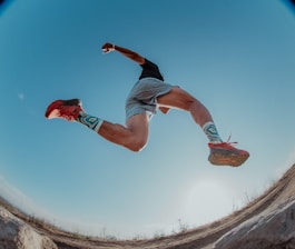 a man flying through the air while riding a skateboard