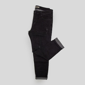 a pair of black jeans sitting on top of a white floor