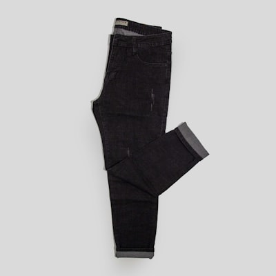 Folded black tapered denim — photo by TuanAnh Blue on Unsplash