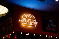 a neon sign on the wall of a restaurant