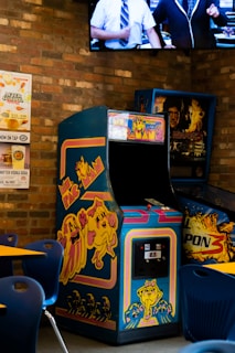 a video game machine sitting next to a brick wall