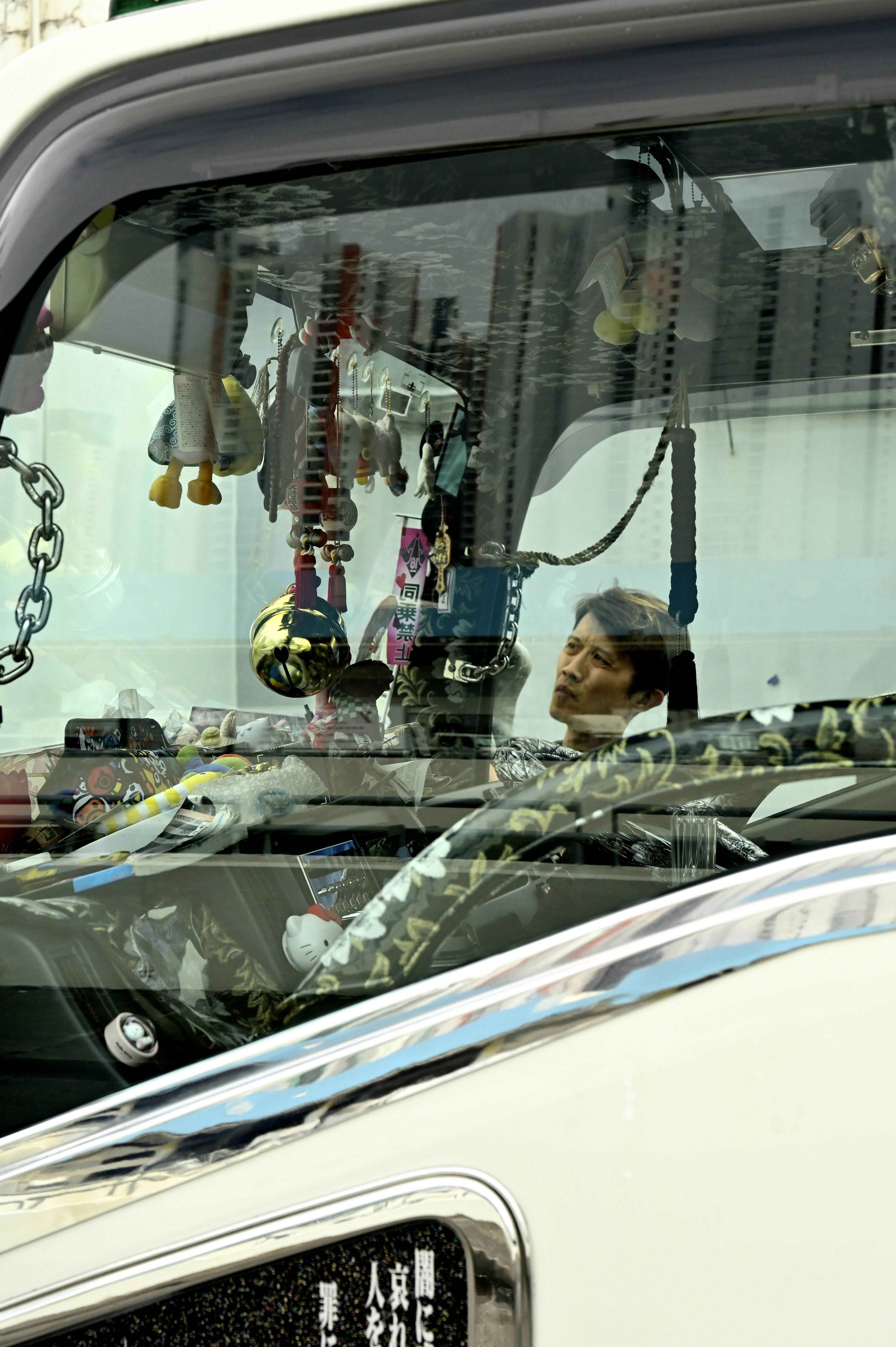 a man sitting in the back of a white truck