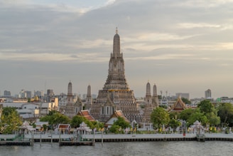 a very tall building sitting on the side of a river