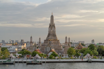 a very tall building sitting on the side of a river