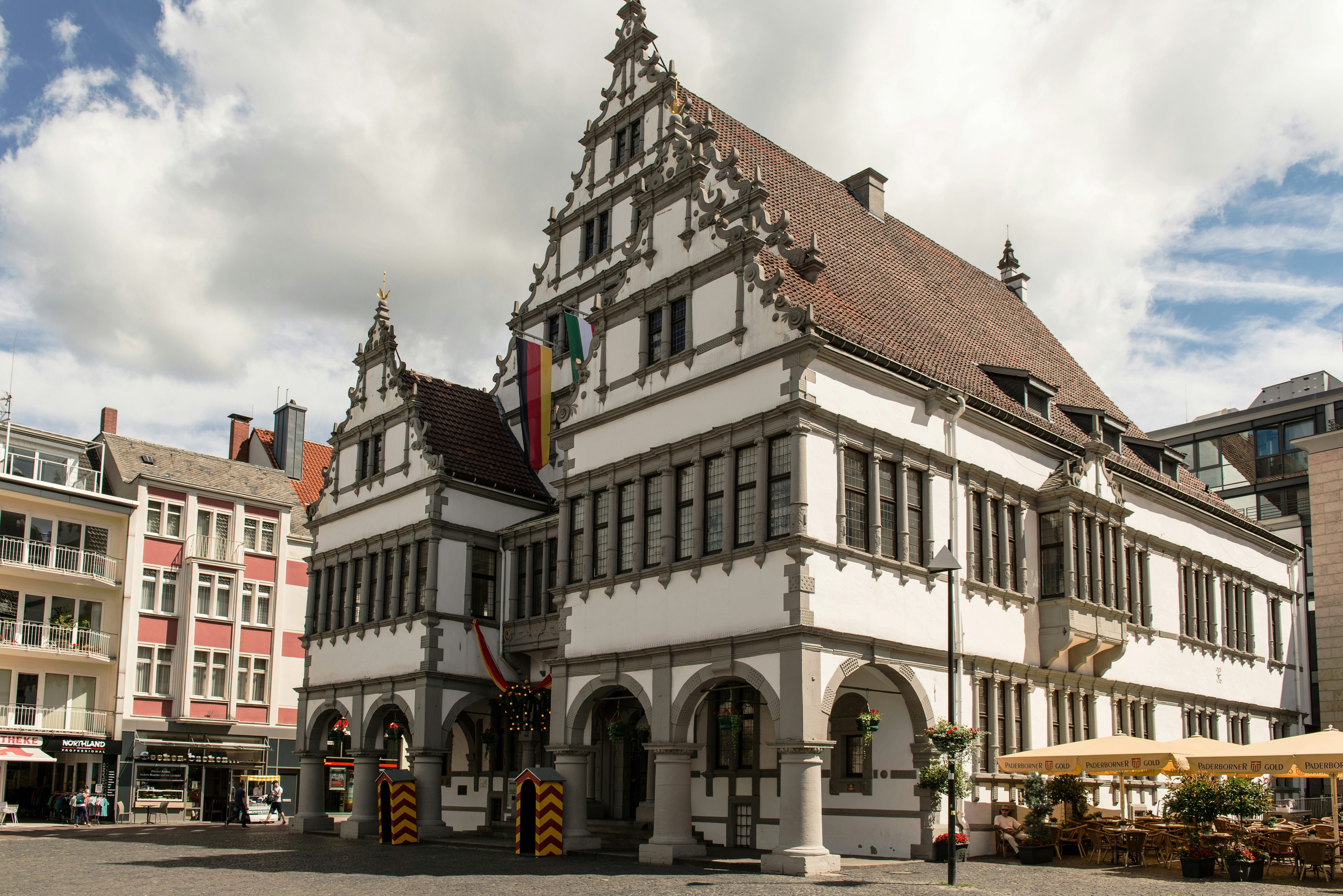 a large white building with a flag on top of it