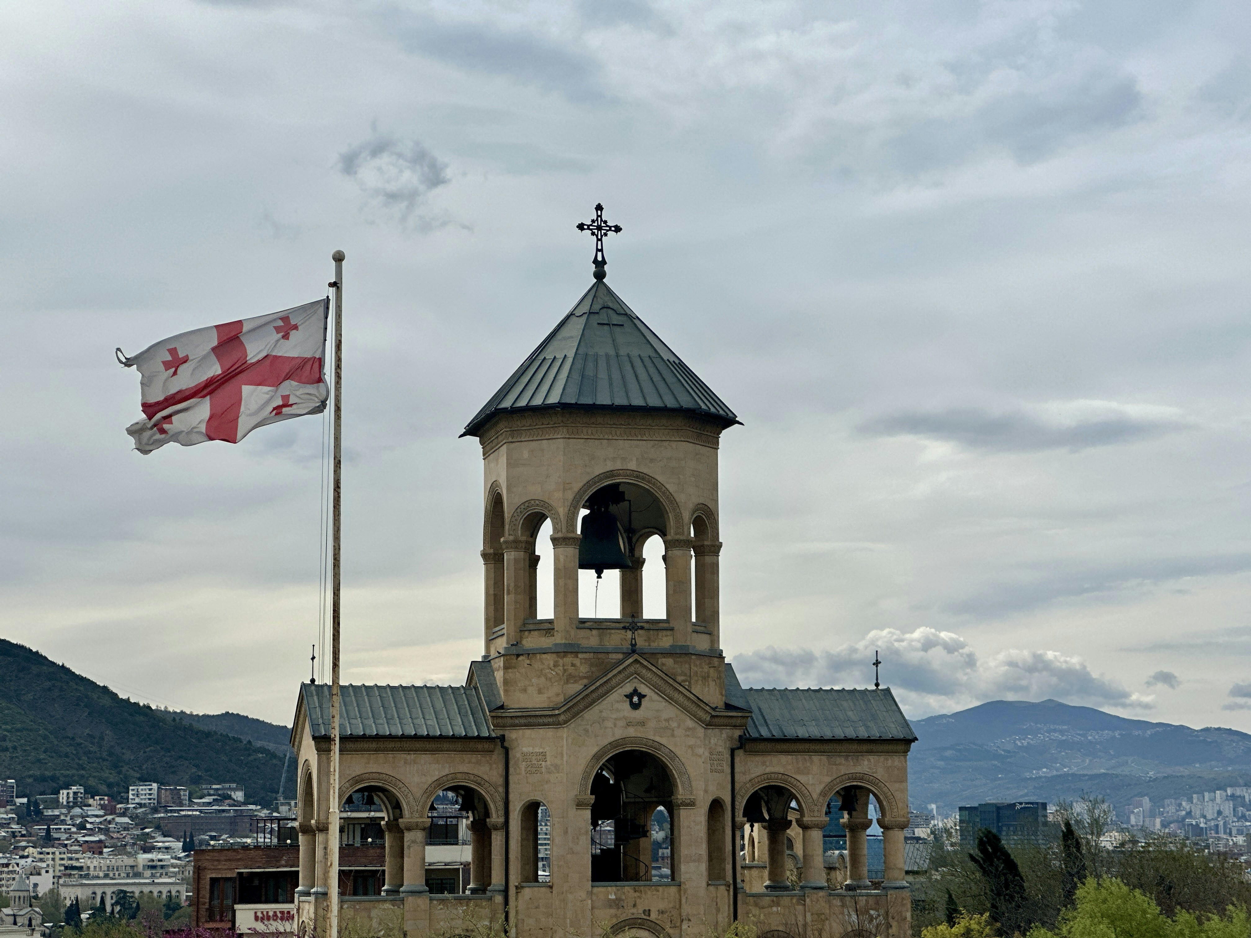 an old building with a flag flying in front of it